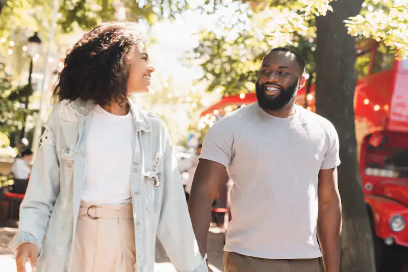 cheerful young african couple walking together