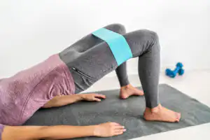 Woman laying on her back pushing her hip upwards