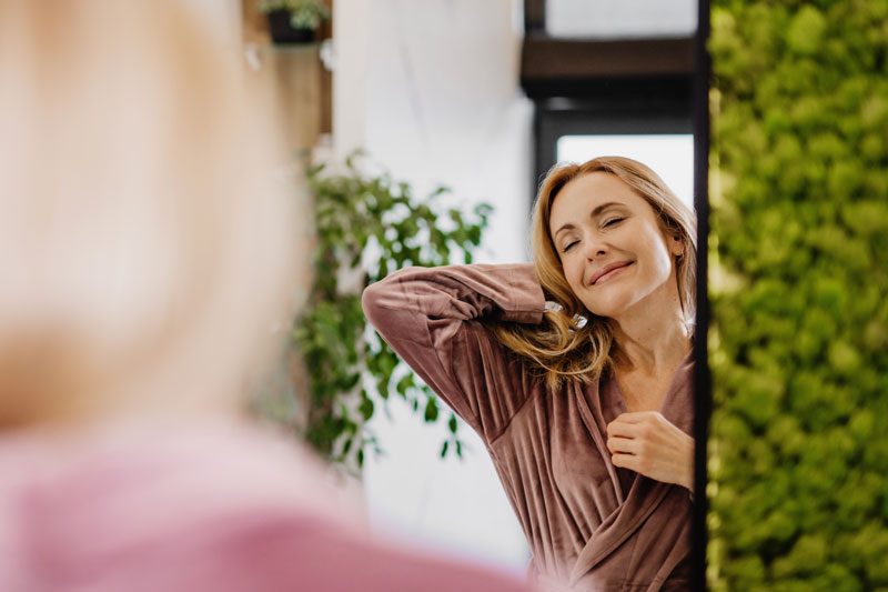 happy smiling woman in front of the mirror