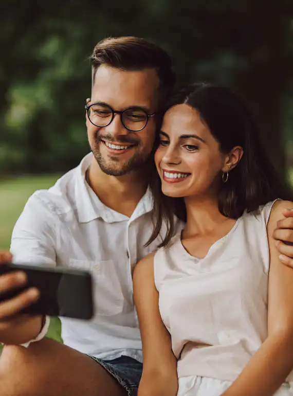 two happy people taking pictures